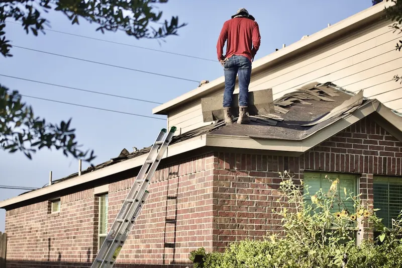 Professional roofer working on a residential roof in Woodbrook